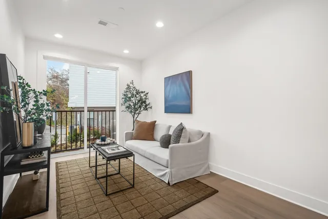 a living room with furniture and a potted plant