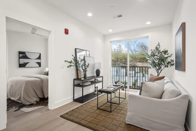 a living room with furniture and a potted plant