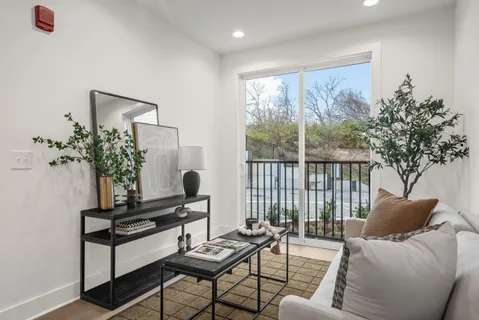 a living room with furniture and a potted plant