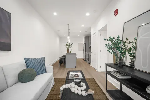 a living room with furniture and wooden floor