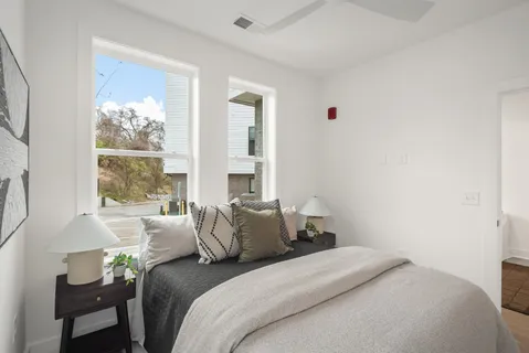 a bedroom with a bed and a window