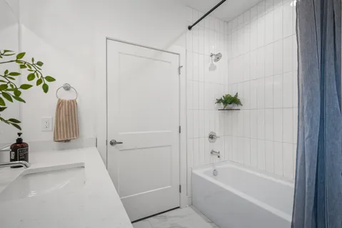 a view of walk in closet with wooden floor