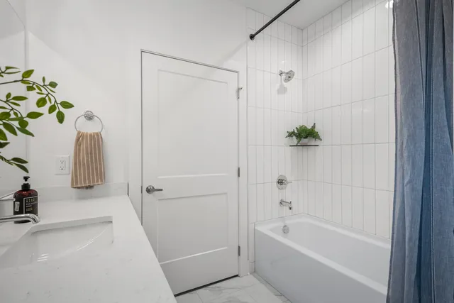 a view of walk in closet with wooden floor