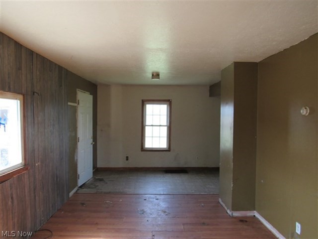 3845 Bower Road Rootstown, OH 44272 - Photo 5 of 20 Spare room with wooden walls and dark wood-type flooring