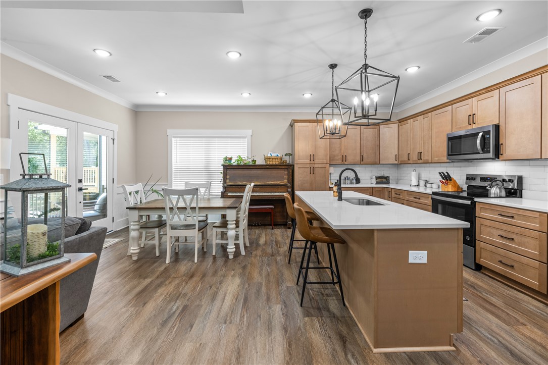 322 Thompson Street Pendleton, SC 29670 - Photo 14 of 38 Gleaming floors and a spacious island anchor this light-filled kitchen and dining area.