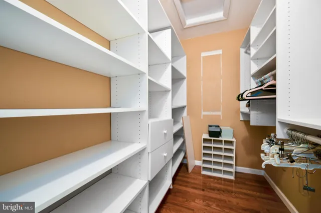 a hallway with cabinets and wooden floor