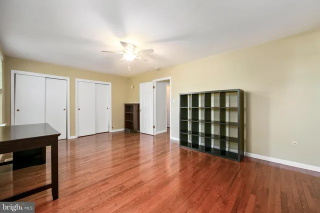 an empty room with wooden floor and cabinet