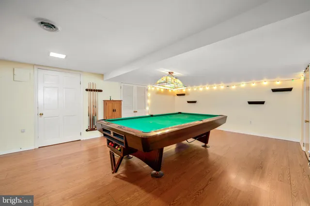 a room with pool tables and windows