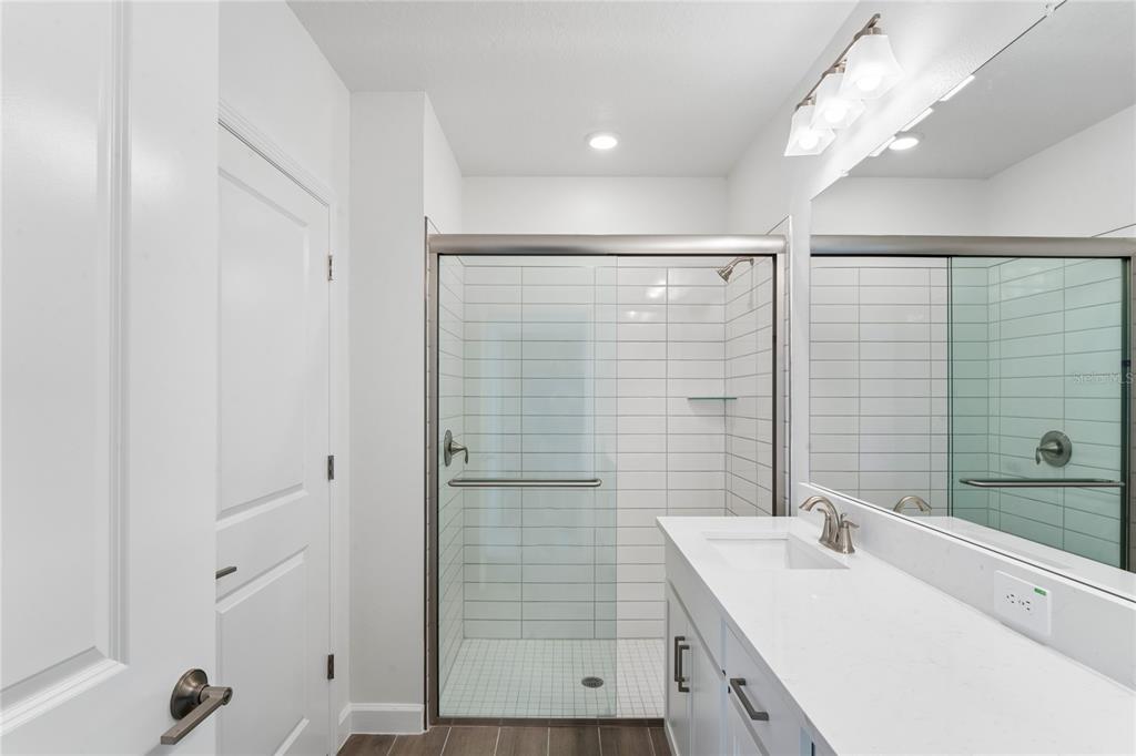 6692 Homebound Way New Port Richey, FL 34653 - Photo 24 of 47 a bathroom with a shower sink and mirror