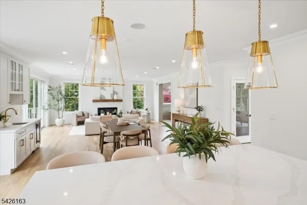 a living room with fireplace furniture and a chandelier