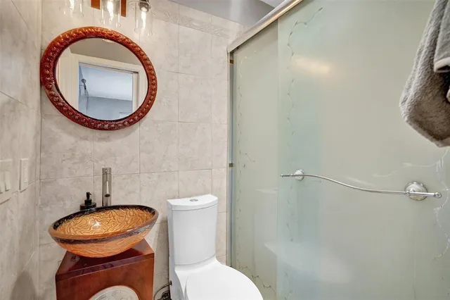 a bathroom with a toilet and a mirror