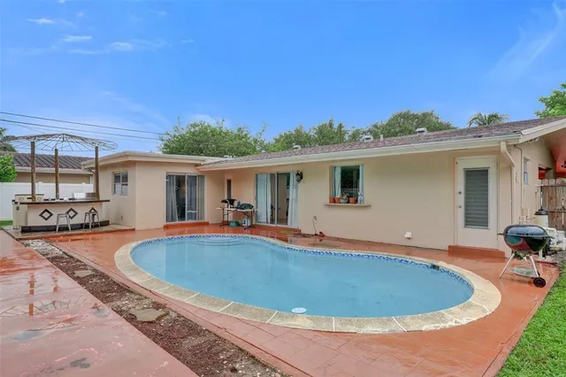 a view of a house with swimming pool and porch