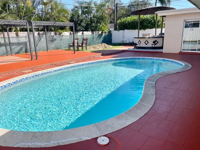 a view of a swimming pool with an outdoor seating