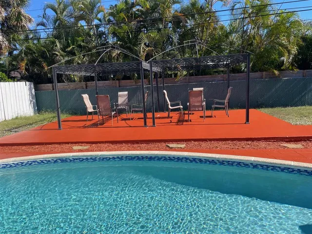 a view of a tennis ground with trees in the background