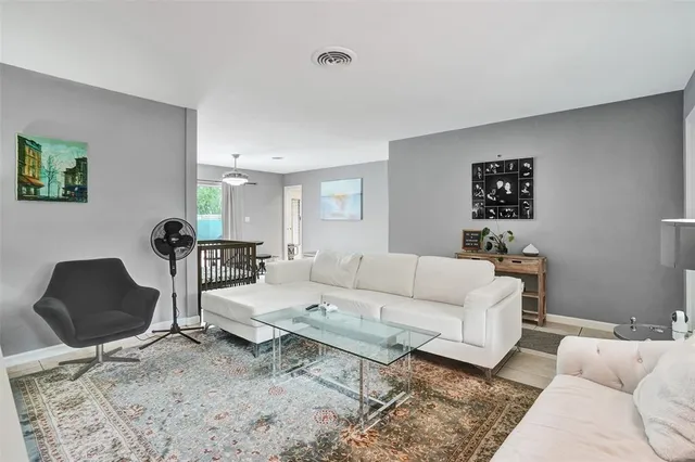 a living room with furniture and a lamp