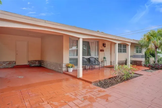 a view of a house with backyard porch and sitting area
