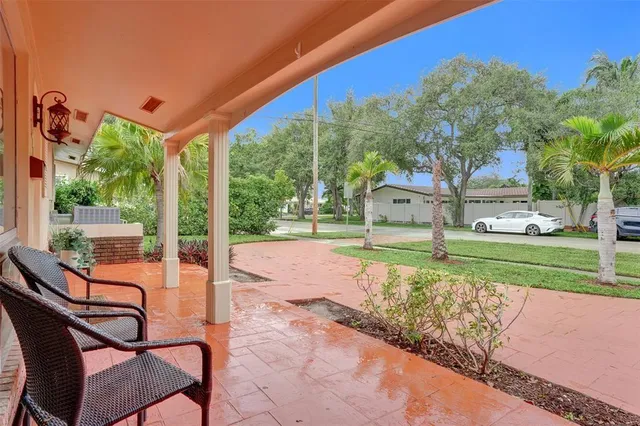 a house view with a sitting space and garden