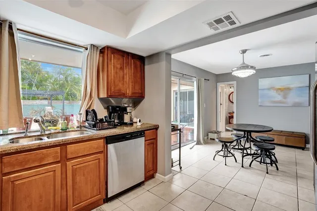 a kitchen with sink cabinets and dining table view
