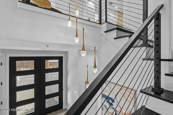 a kitchen with stainless steel appliances granite countertop a sink a stove a refrigerator and a refrigerator