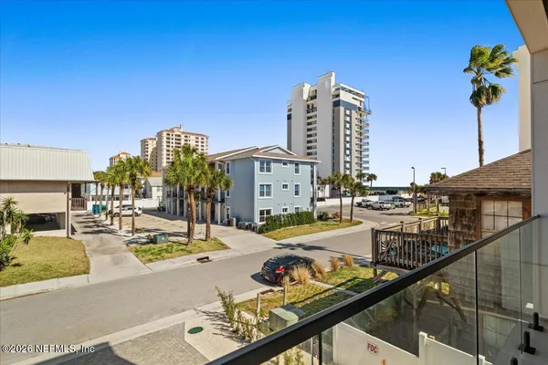 a view of a tall building with a palm tree in the background