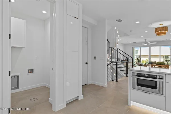 an empty room with a window and a ceiling fan