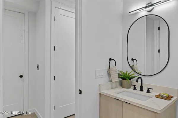 a living room with furniture flowerpot and a chandelier