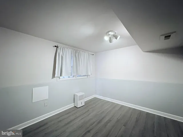 a view of room with wooden floor