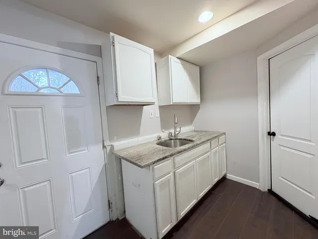 a kitchen with a sink cabinets and a window