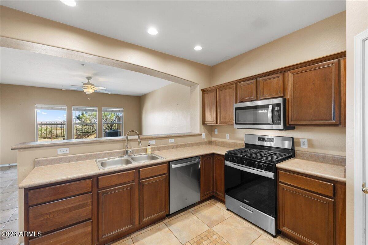 813 Alfonse Road Clarkdale, AZ 86324 - Photo 24 of 41 a kitchen with stainless steel appliances a stove sink microwave and cabinets