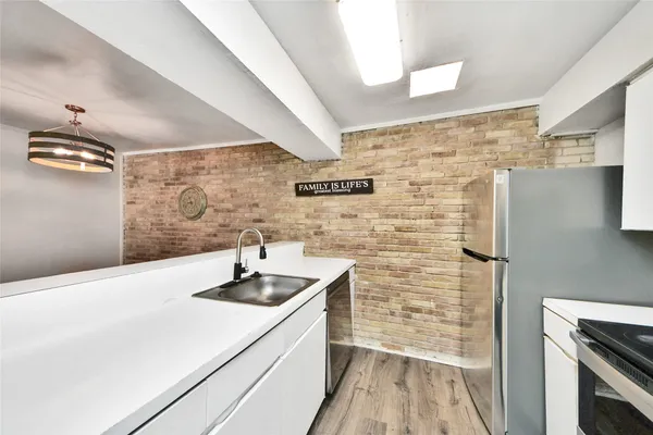a bathroom with a sink a mirror and shower