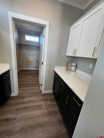 a room with wooden floor and cabinets