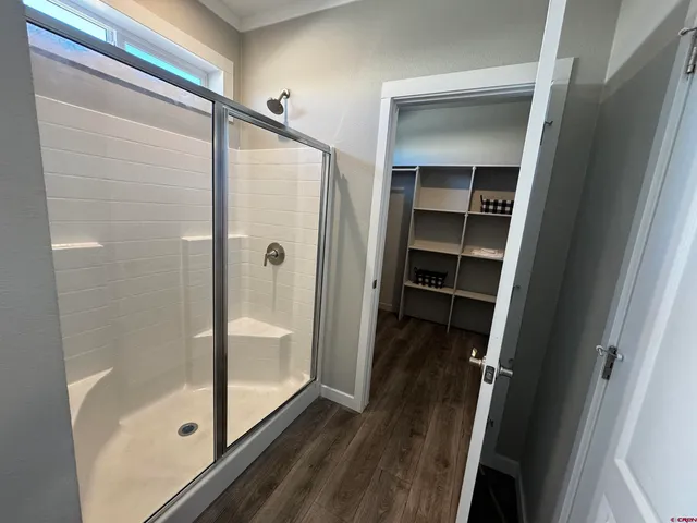 a view of walk in closet with empty racks