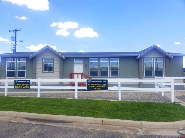 a view of a house with a swimming pool and a yard
