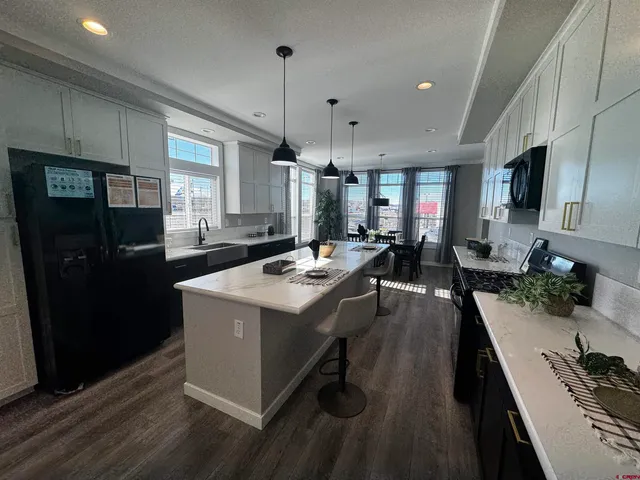 a living room with furniture and a ceiling fan