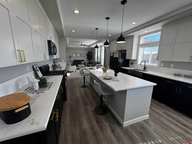a kitchen that has a sink stainless steel appliances a counter space and a window