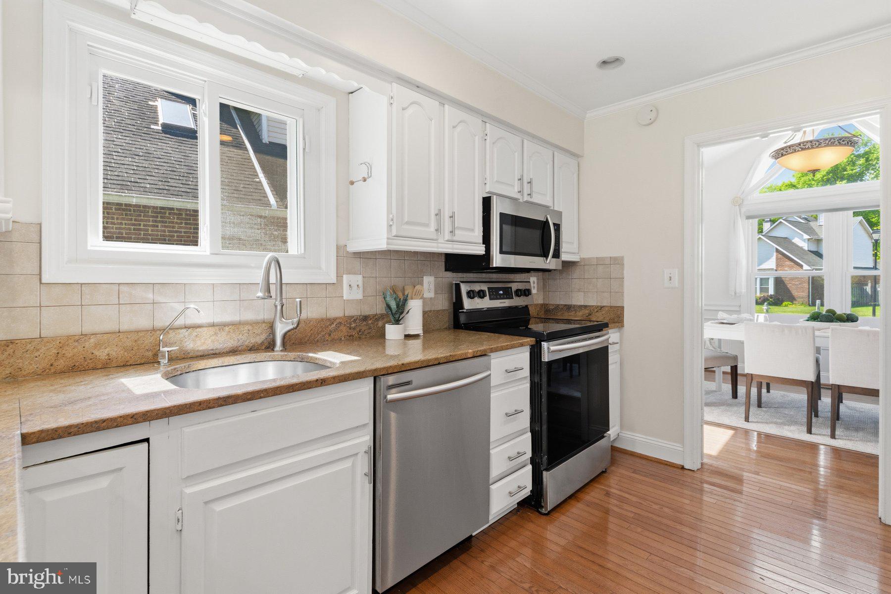 14215 Greenview Drive Laurel, MD 20708 - Photo 12 of 35 a kitchen with appliances a sink and a window
