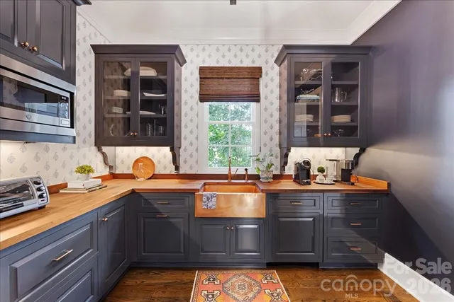 a view of a center kitchen island furniture wooden floor and windows