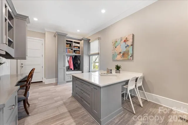 a kitchen with a table chairs sink and cabinets