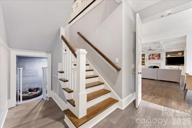 a white toilet sitting next to a bathroom sink with a potted plant