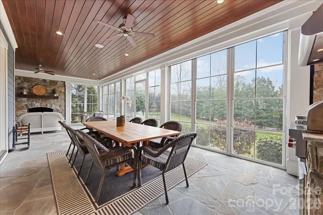 a living room with furniture large window and a fireplace