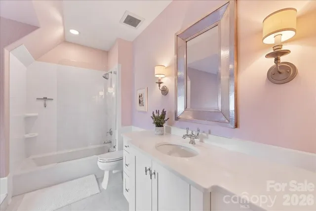 a bathroom with a sink a toilet and mirror