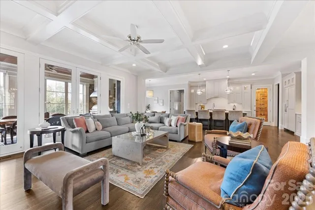 a kitchen with a dining table chairs wooden floor and appliances