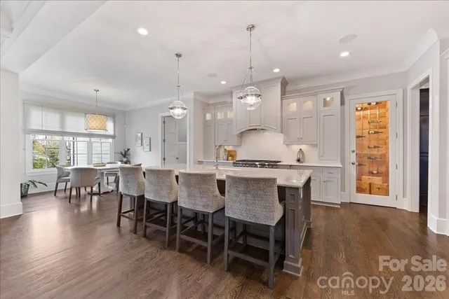 a view of a dining room with furniture wooden floor and chandelier