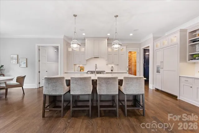 a kitchen with granite countertop white cabinets and sink