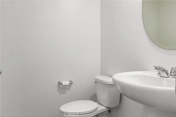 a white toilet sitting next to a white sink