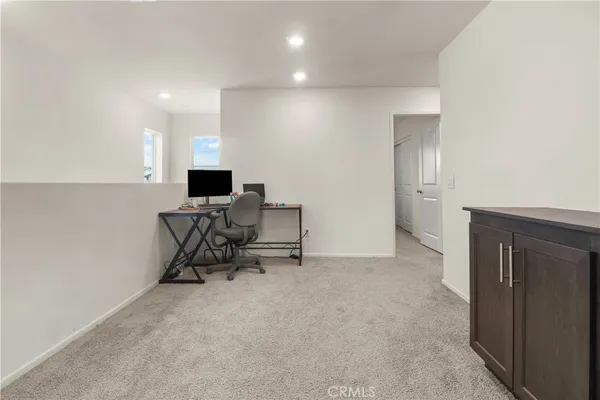 a view of work space with furniture and wooden floor