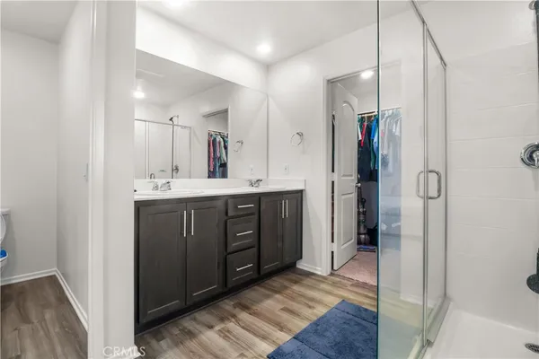 a spacious bathroom with a shower sink and a mirror