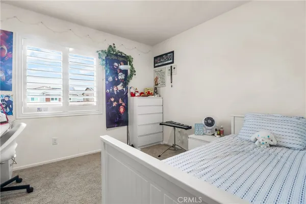 a room with a bed and a table chair