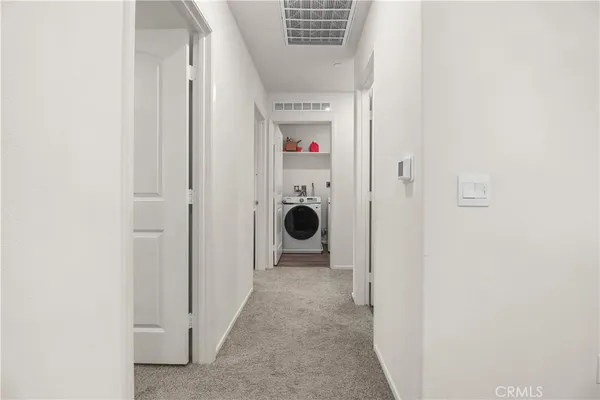 a view of a hallway with washer and dryer