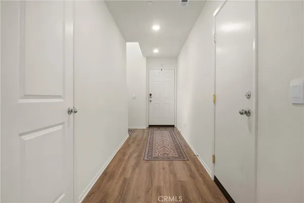 a view of a hallway with wooden floor